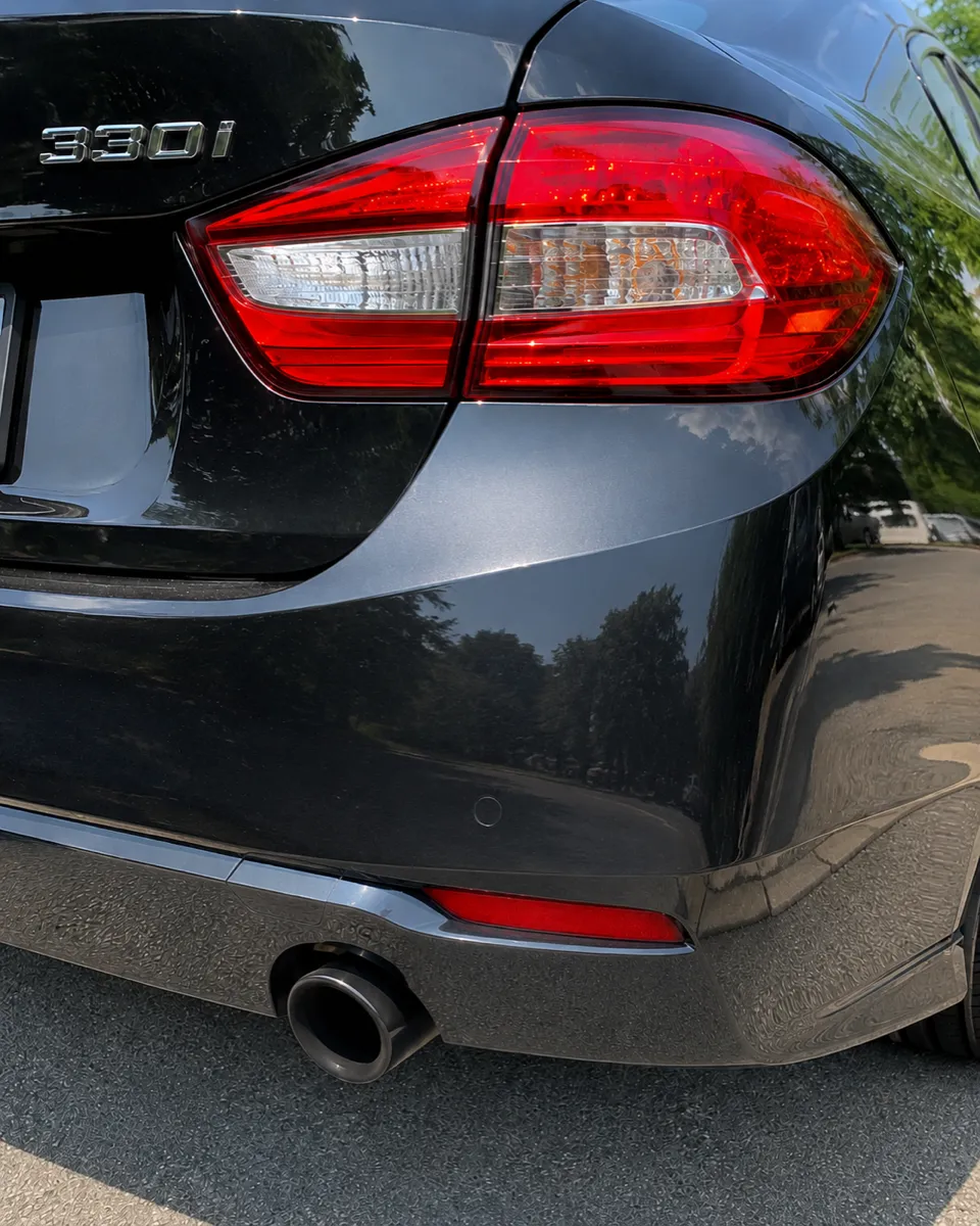 BMW 330i rear bumper dent repaired, original finish preserved in Mesa, AZ, after