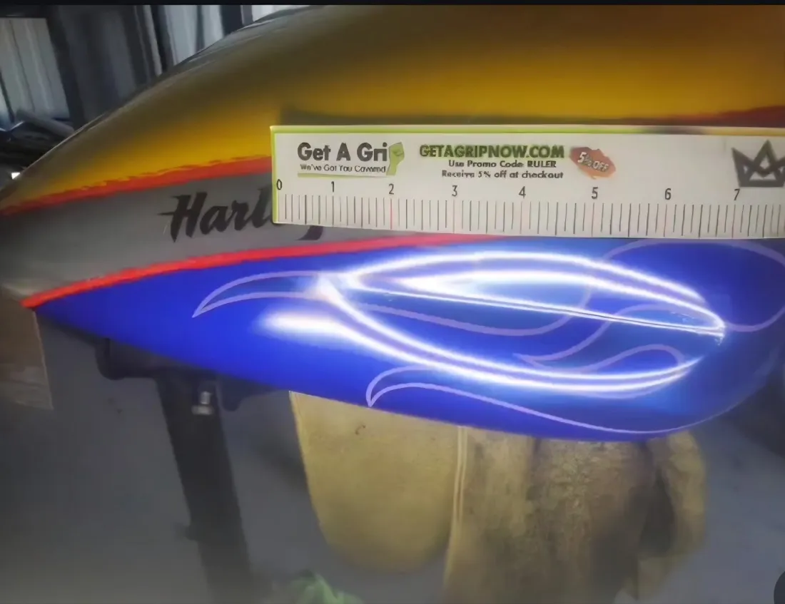 Custom flame Harley-Davidson fuel tank dent repaired with PDR, blue flame paint preserved in Mesa, AZ, before