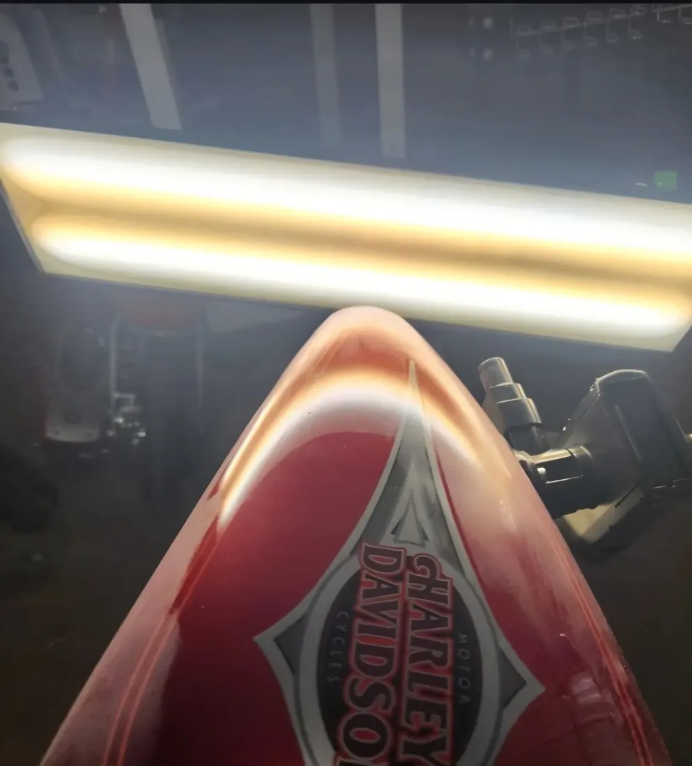 Red Harley-Davidson motorcycle tank dent removed with paintless dent repair in Mesa, AZ, after