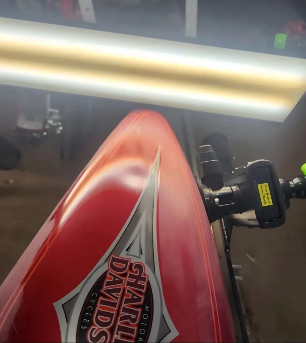 Red Harley-Davidson motorcycle tank dent removed with paintless dent repair in Mesa, AZ, before