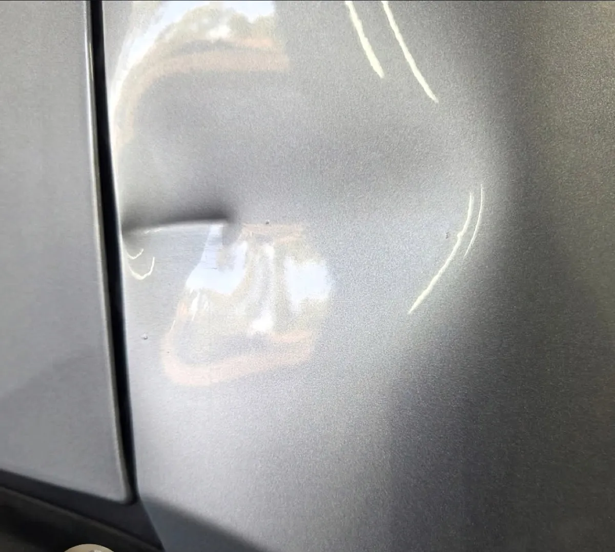 Large dent by the door seam removed with paintless dent repair in Mesa, AZ, before